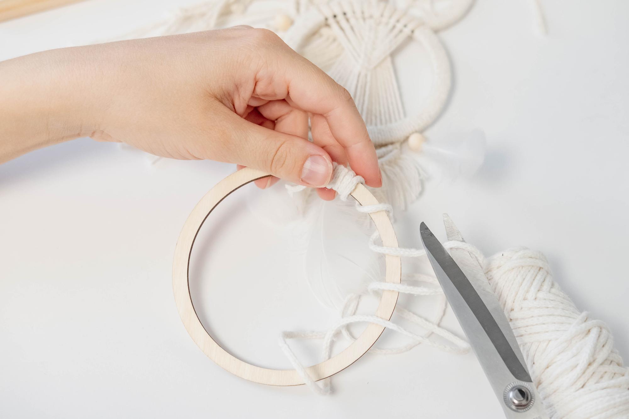studio hands finishing a hoop piece
