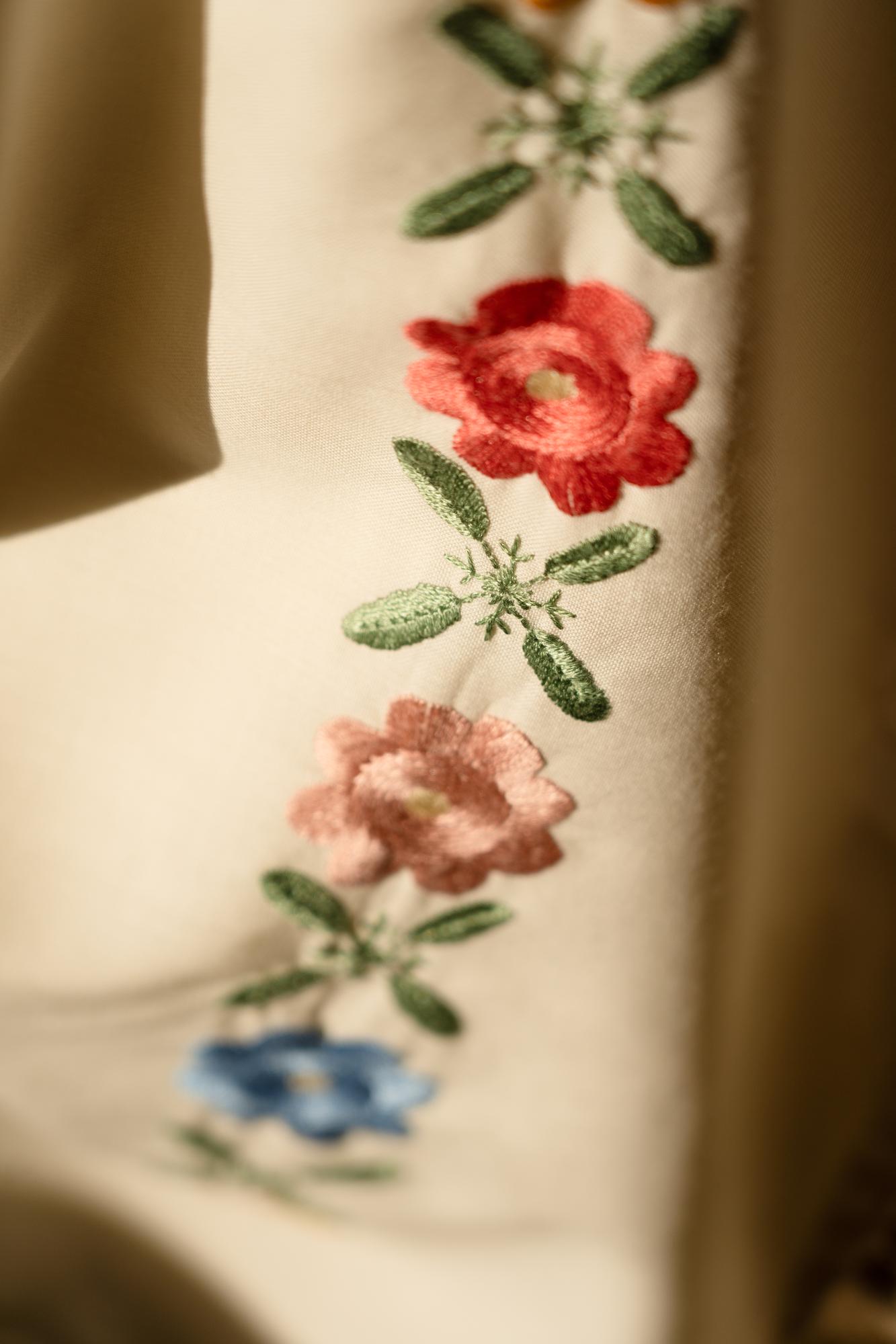 close-up of stitched floral embroidery on linen